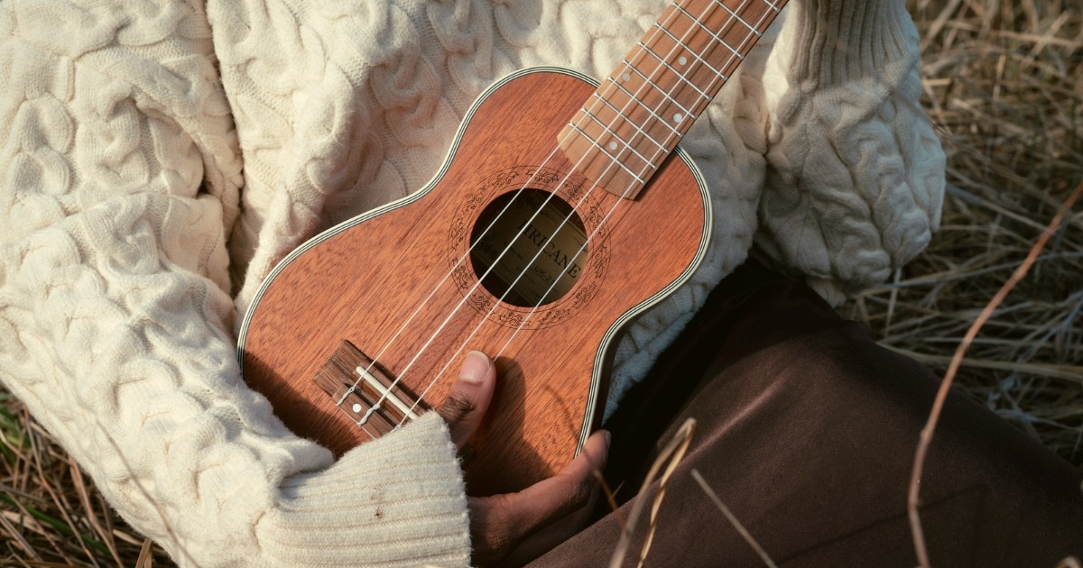 holding an ukulele